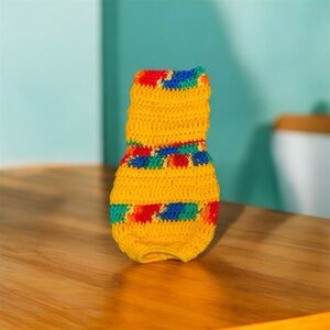 Colorful crocheted plastic grocery bag holder. Yellow striped with blue green